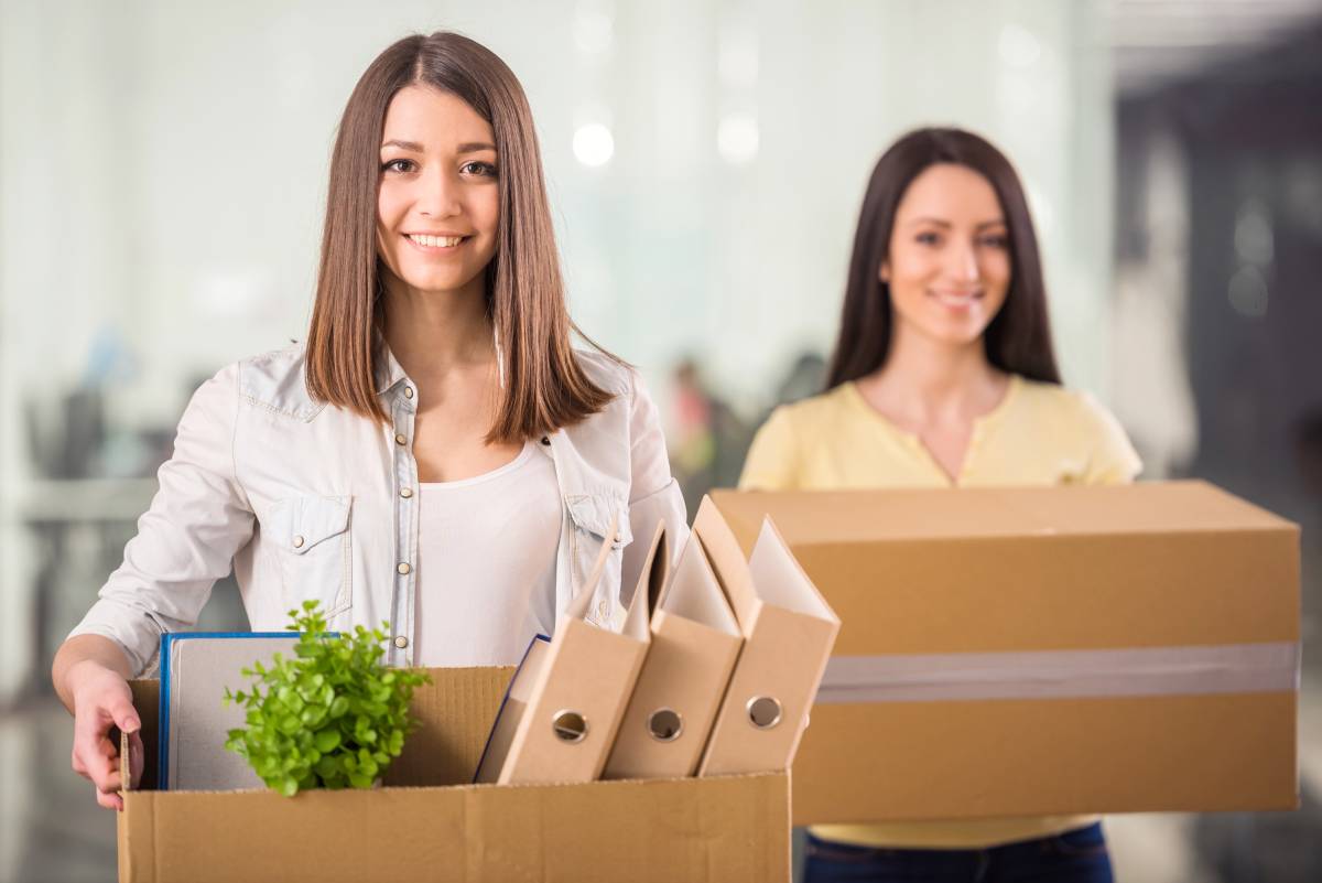 Two women returning to the office after working remotely