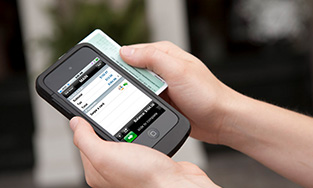 NCR Mobile being used on a smartphone to swipe a card for a transaction