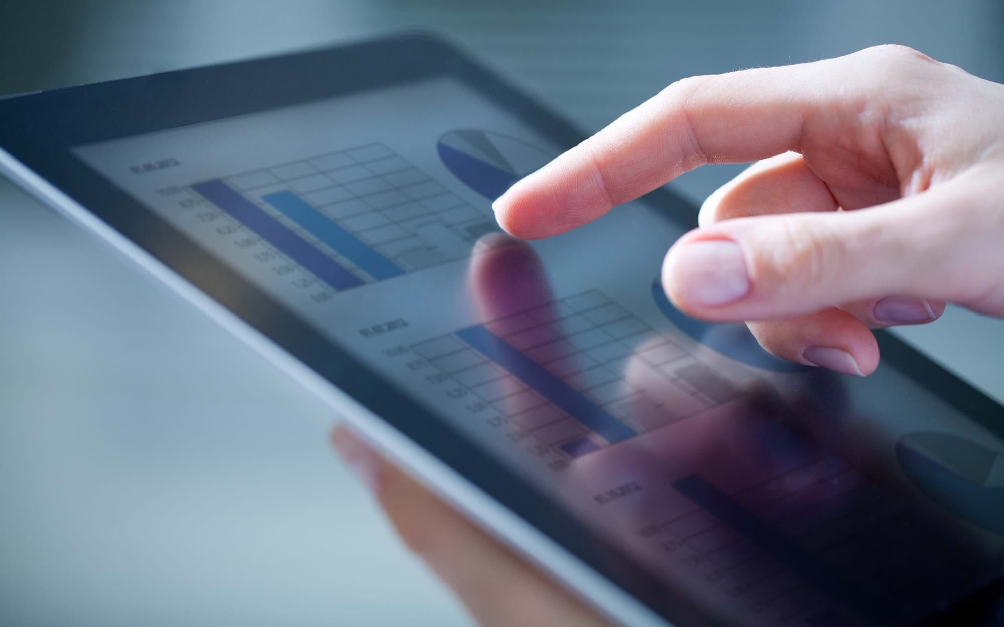 Woman's hand interacting with a tablet device